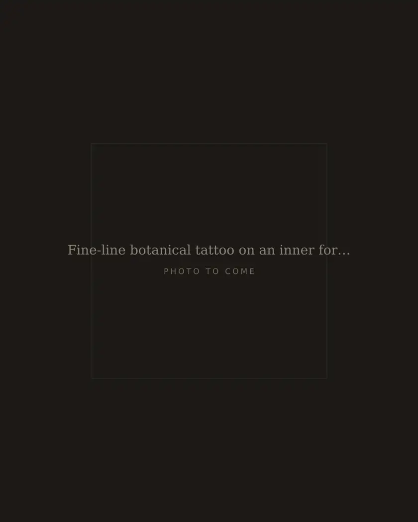 Fine-line botanical tattoo on an inner forearm, healed