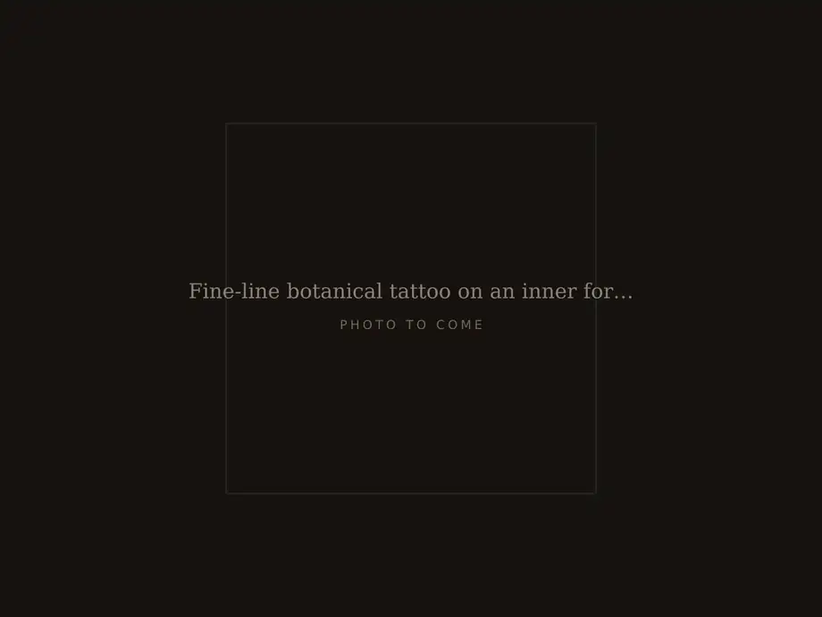 Fine-line botanical tattoo on an inner forearm