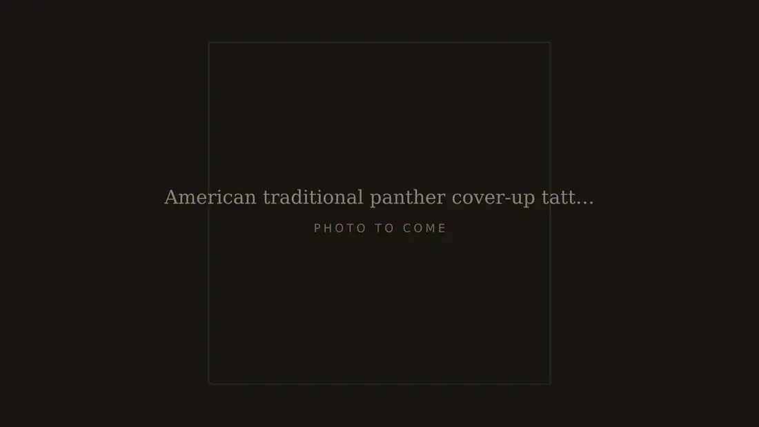 American traditional panther cover-up tattoo on an upper arm, healed, hiding an older faded name