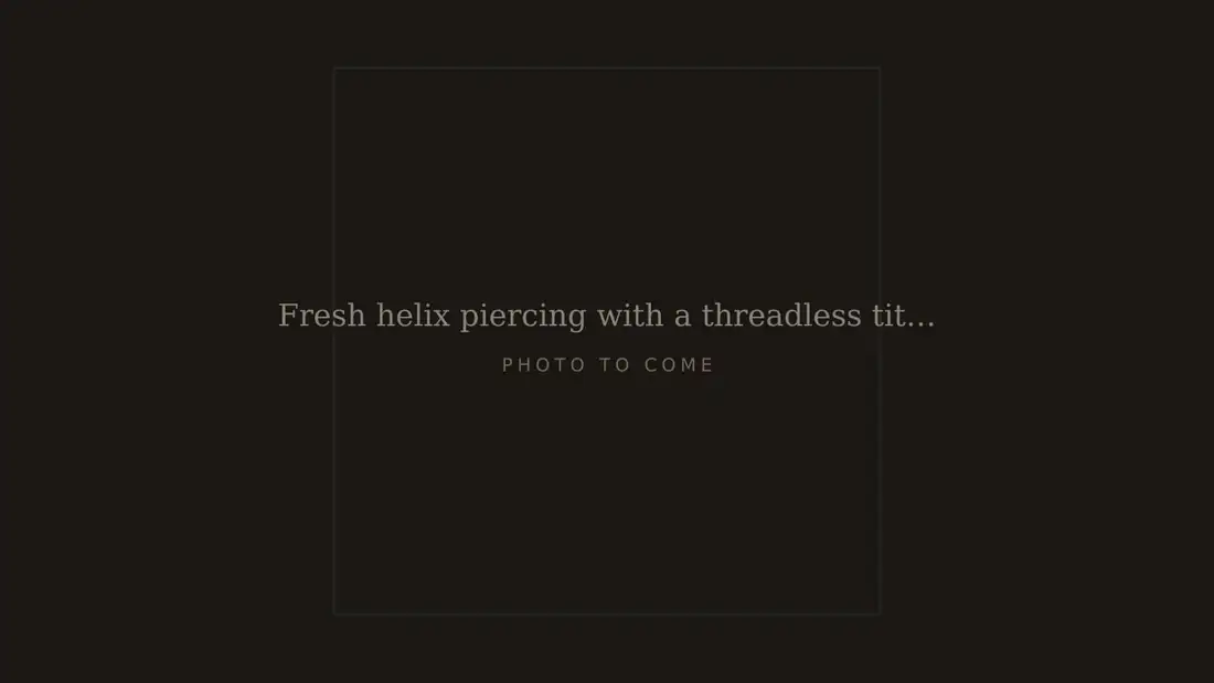 Fresh helix piercing with a threadless titanium stud, photographed on the day it was done