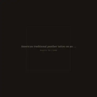 American traditional panther tattoo on an outer forearm in black and red