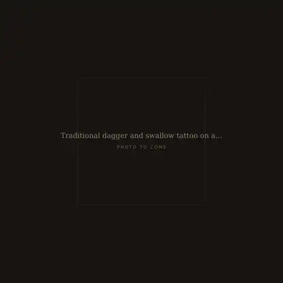 Traditional dagger and swallow tattoo on an upper arm, fresh
