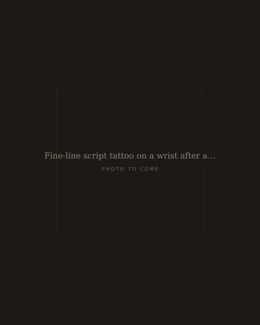 Fine-line script tattoo on a wrist after a touch-up, healed
